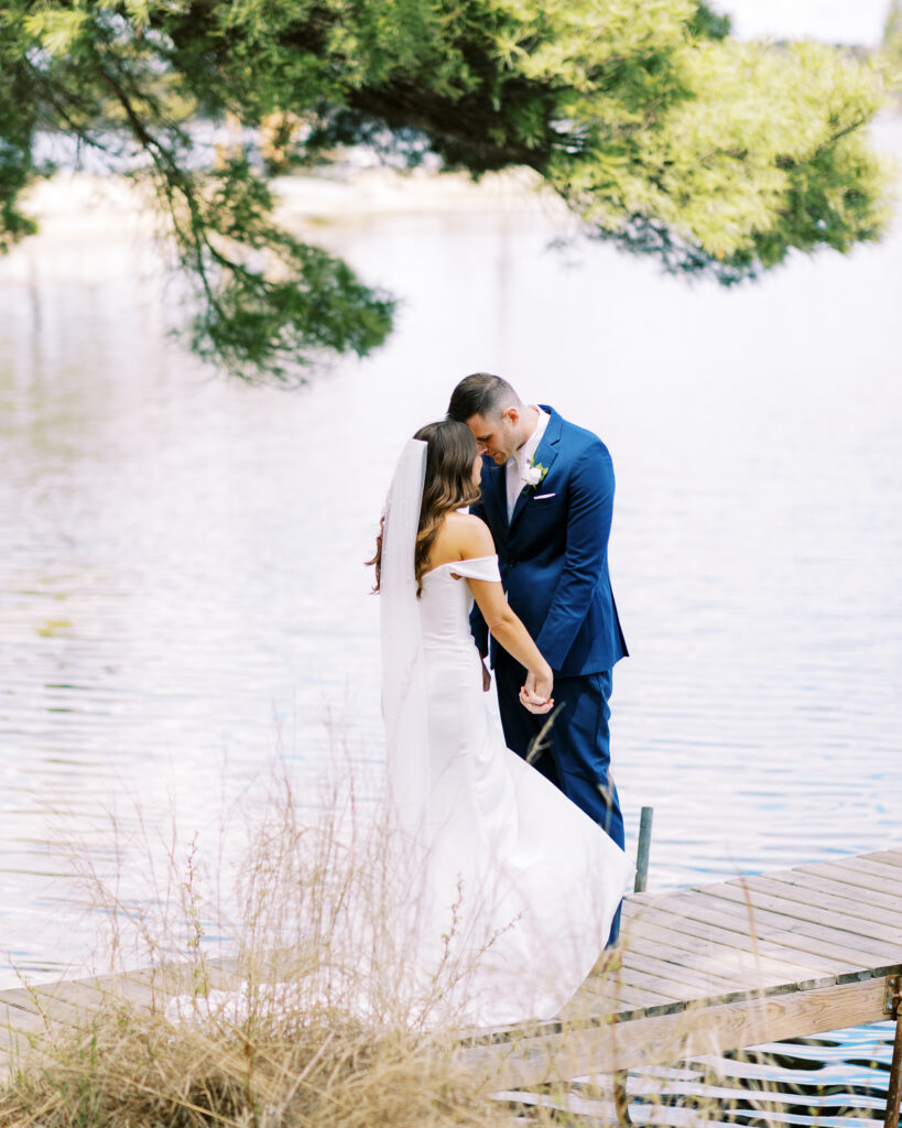 Special prayer on the dock over the lake. Groom and bride.