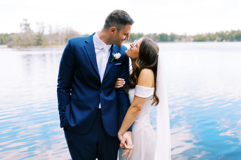 Bride and groom looking at each other with smiles.