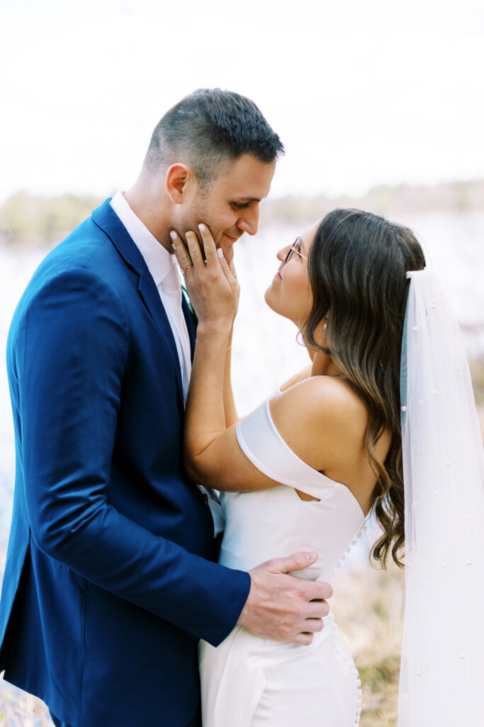 Bride and groom with love looking at each other and smiling.