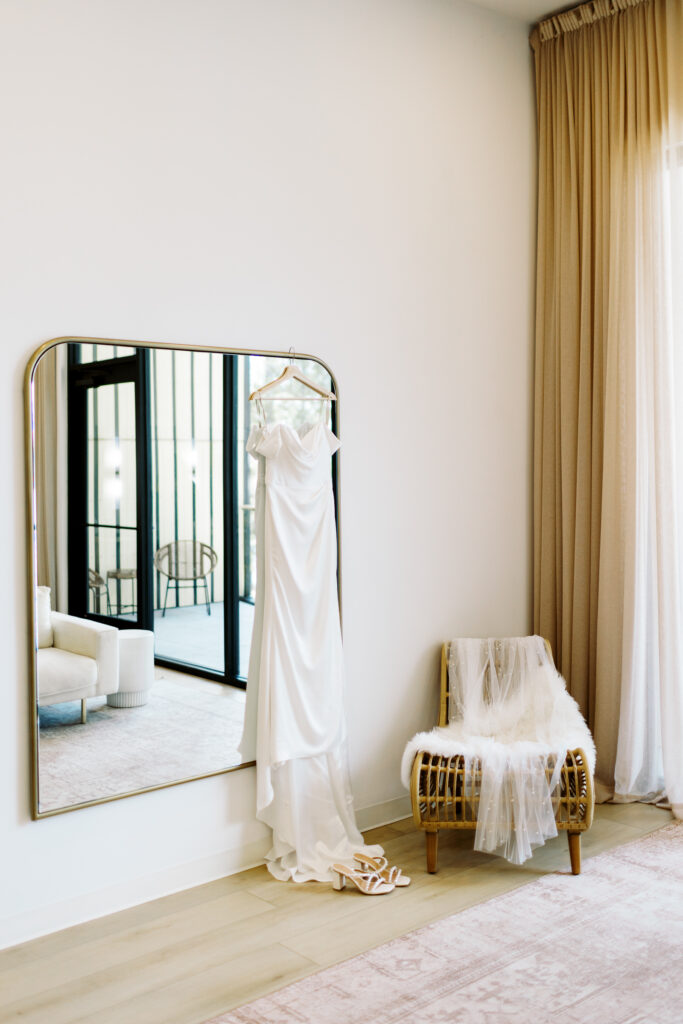 Catalyst by Nature Link event center. Wedding dress hanging on the mirror in the room.