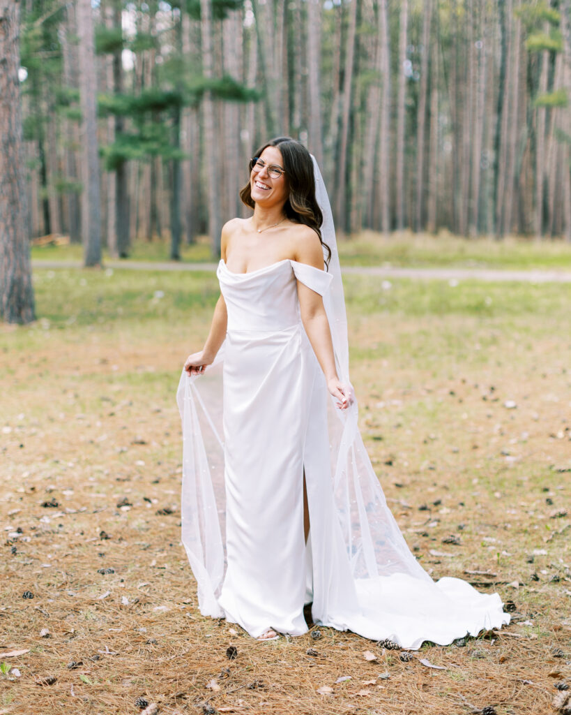 Ride laughing and twirling her long vail. Captured by Minnesota wedding photographer. Toly Dzyuba photography.