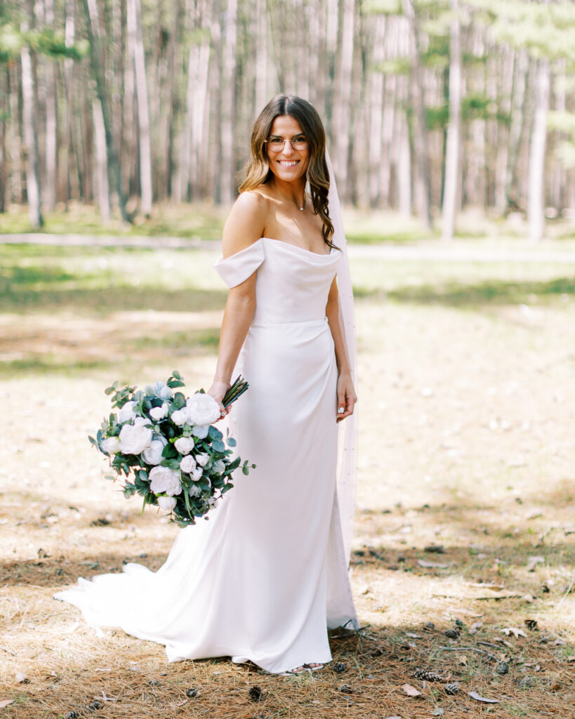 Bride posing with her beautiful large bouquet.