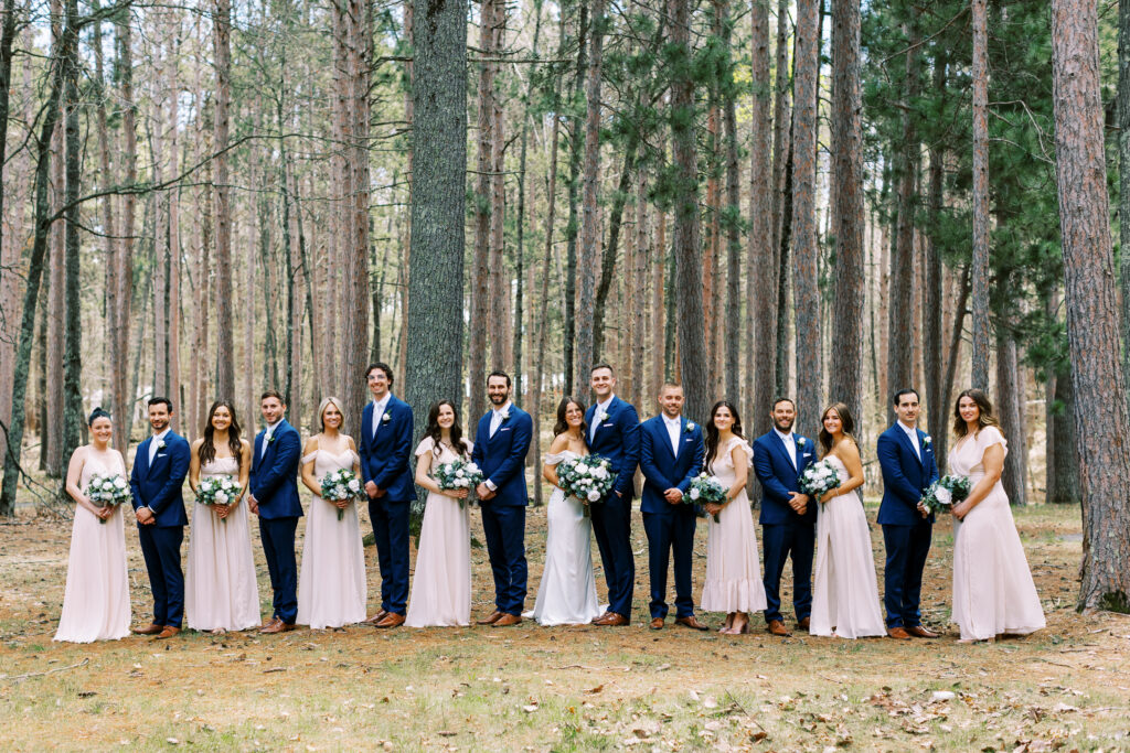 Wedding party photo, everyone standing tall and looking at the camera. Catalyst by nature link resort