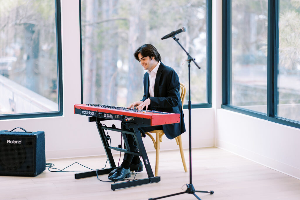 Pianist is playing a tune while sitting before the bride walks down the aisle.