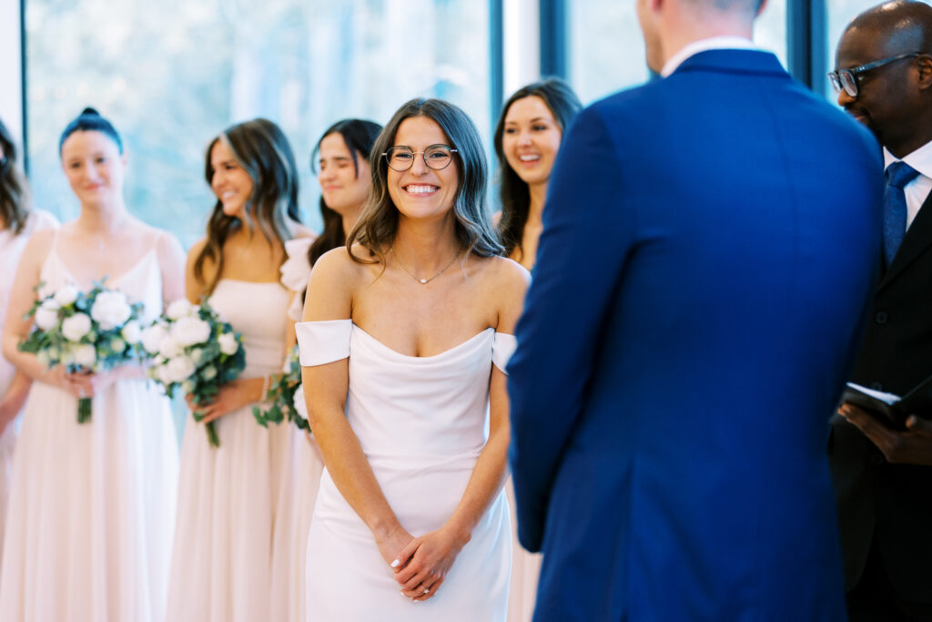 Bride and bridesmaids are laughing during her wedding ceremony.