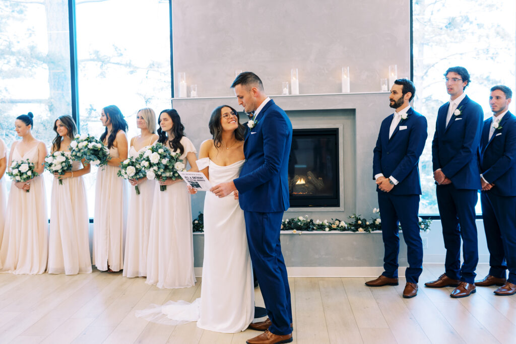 The bride and groom singing while looking at each other and smiled.