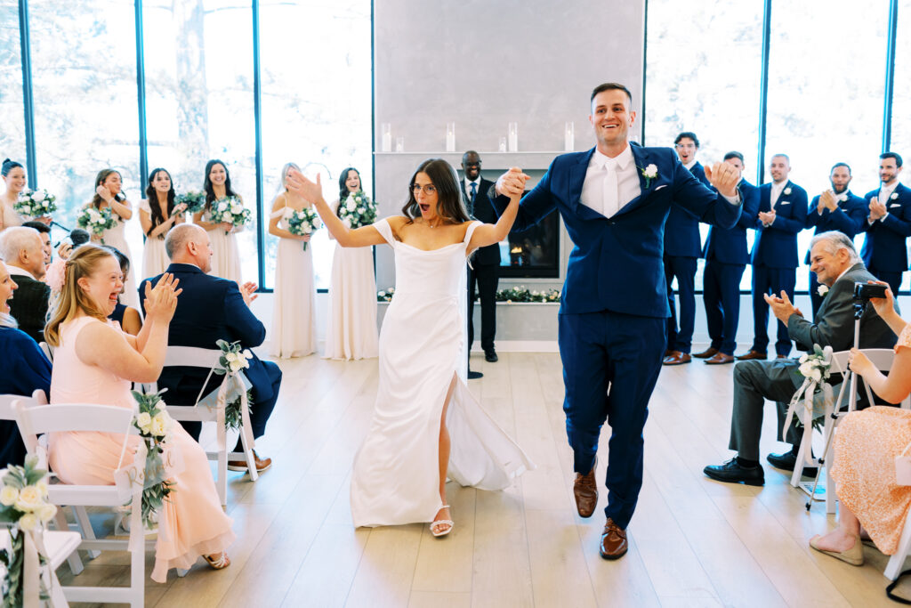 The bride and groom walking down the aisle as husband and wife with cheerful joy in the air.