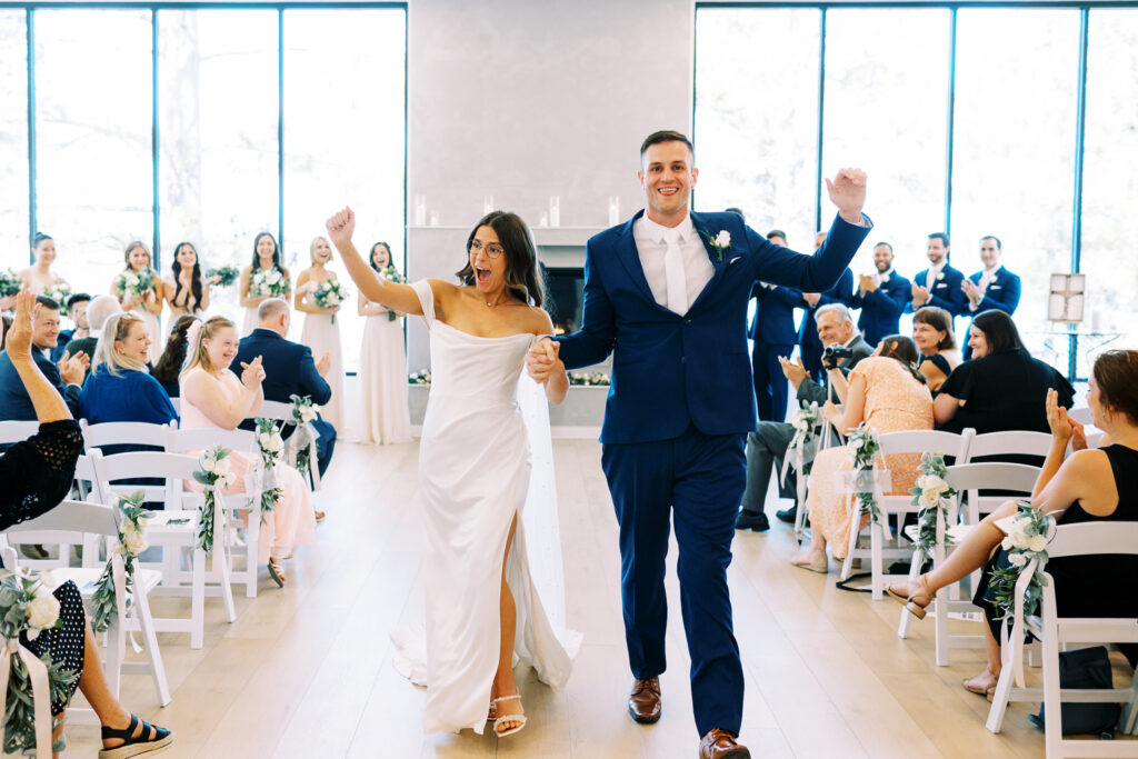 The bride and groom walking down the aisle as husband and wife with cheerful joy in the air.