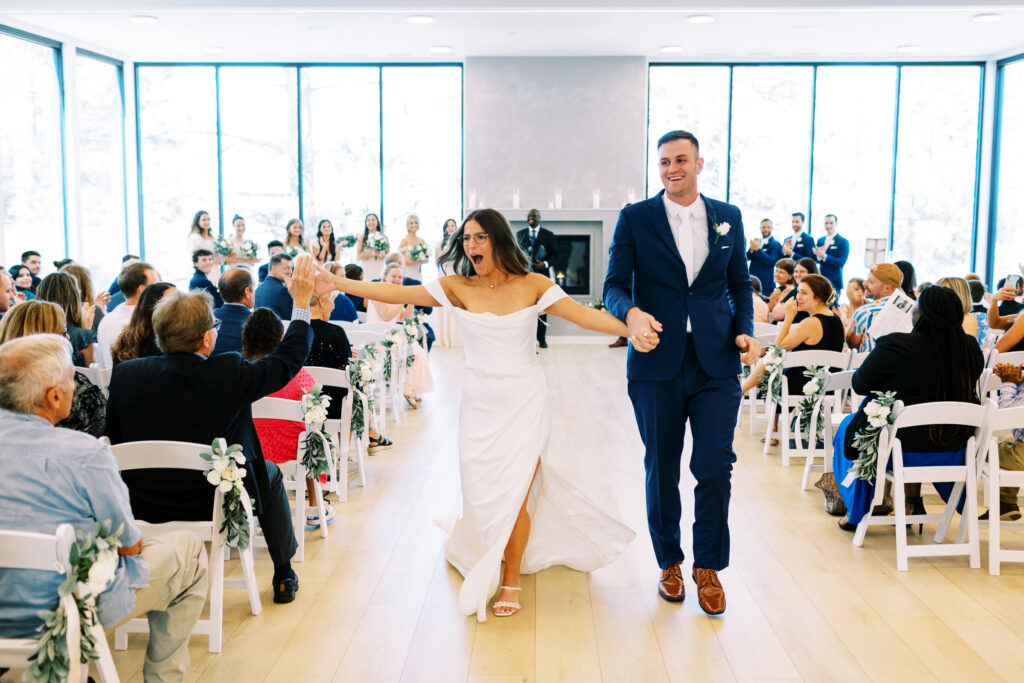 The bride and groom walking down the aisle as husband and wife with cheerful joy in the air.