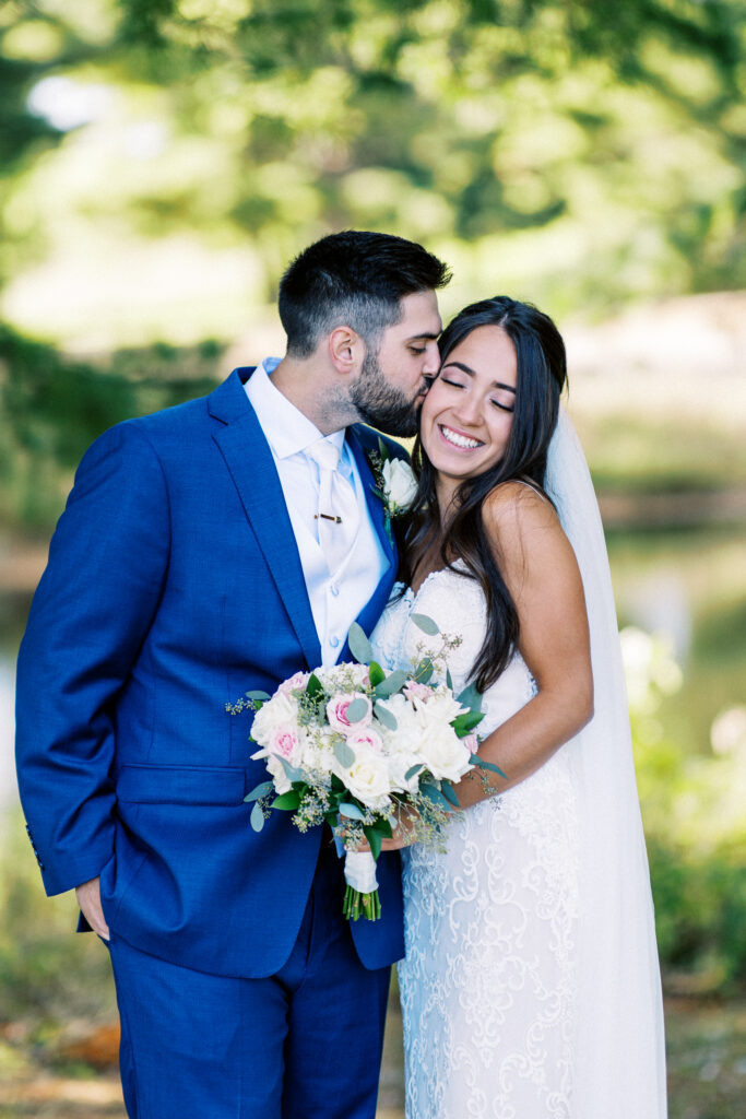 Groom kisses his bride in the cheek. a heartfelt Cabin Elopement in Webster, WI | Minnesota Wedding Photographer.