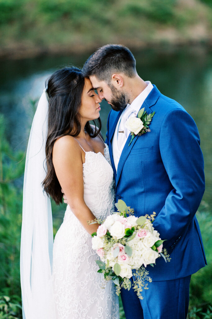 A true heartfelt Cabin Elopement in Webster, WI captured by Minnesota Wedding Photographer as the bride and groom lean together with their heads touching and eyes closed in the candid moment.
