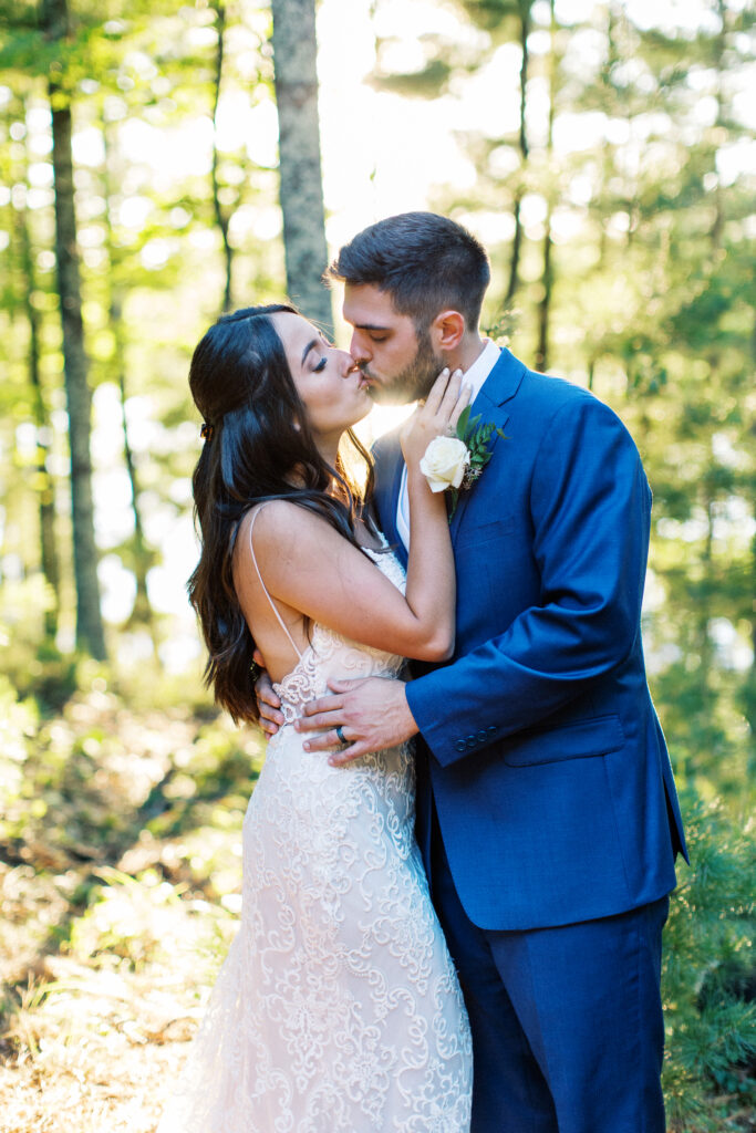 Newlyweds are kissing in the sunset. A true heartfelt Cabin Elopement in Webster, WI | Minnesota Wedding Photographer.
