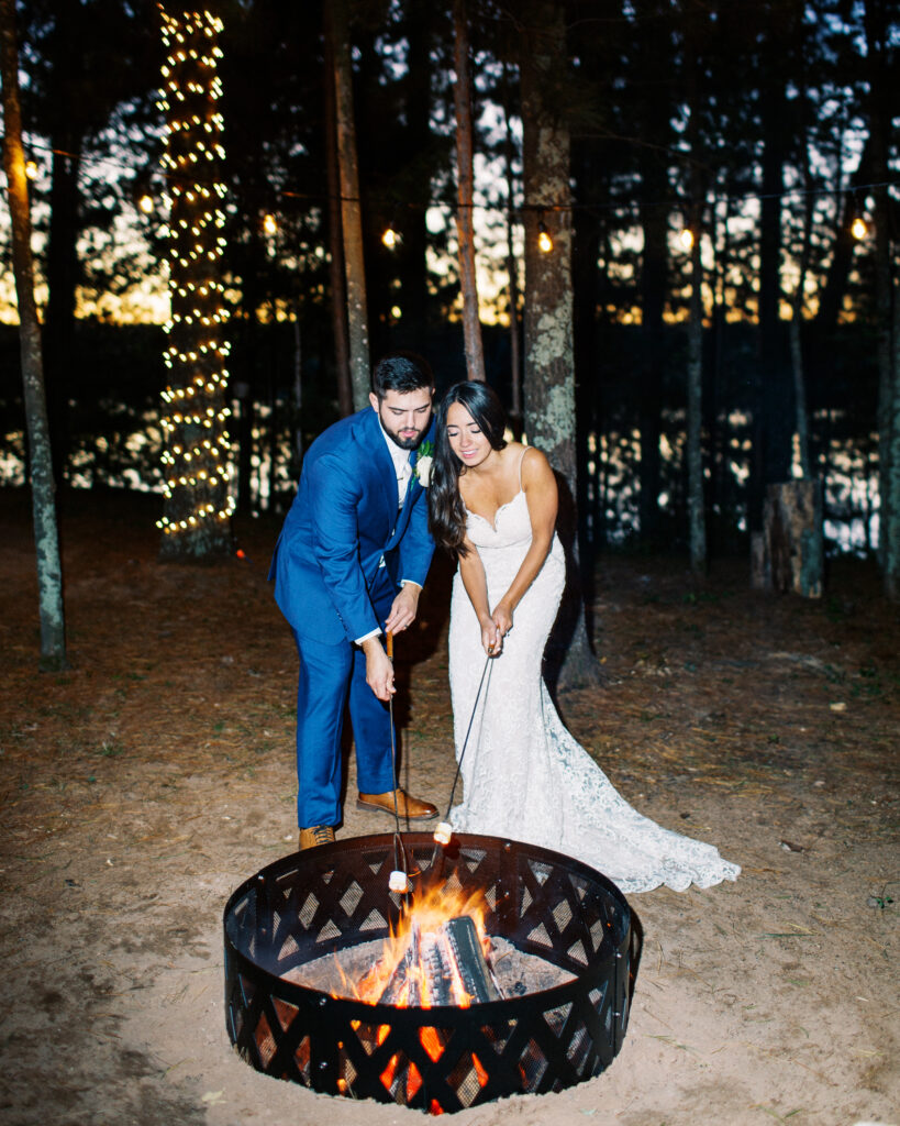 Newlyweds by the cozy bonfire and toasting s'mores as the daylight fades away. This scene occurred during a heartwarming cabin elopement in Webster, WI captured by a Minnesota Wedding Photographer.