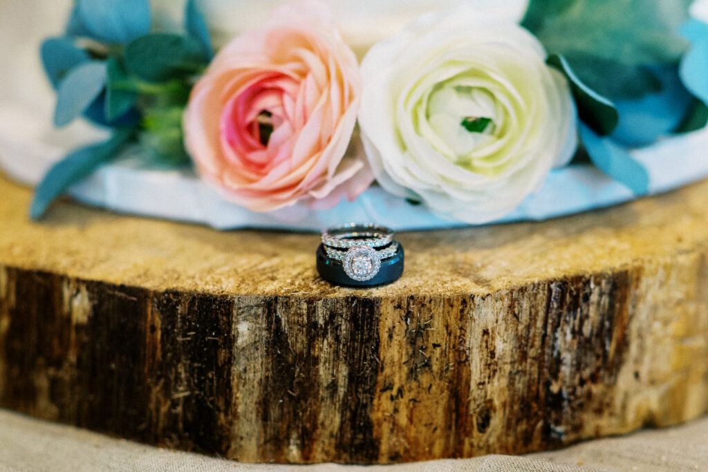 Wedding rings and roses next to each other for the Elopement in Webster, WI.
