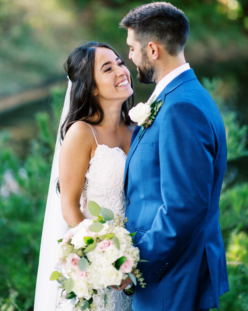 Bride and groom looks at each other with joy. A heartfelt Cabin Elopement in Webster, WI.