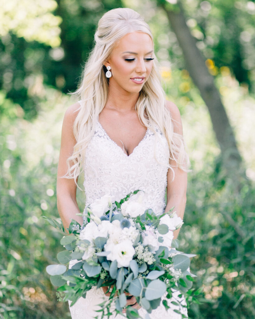 Bride holding her beautiful bouquet while looking away at Legacy Hill Farm wedding venue.