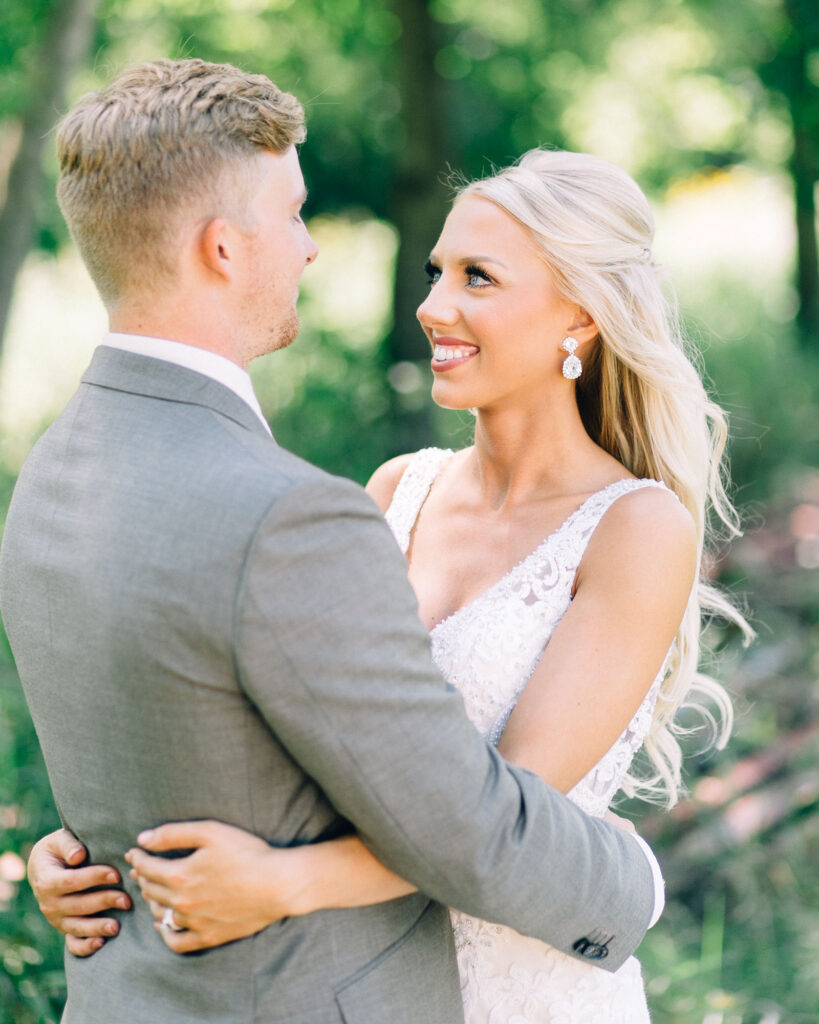 With joy bride and groom looks at each other's eyes.