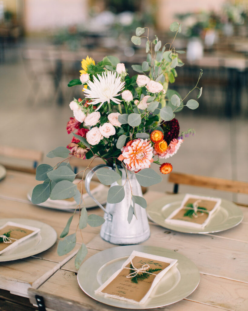 Gorgeous farm-style wedding bouquet resting on the table during the wedding reception at Legacy Hill Farm.