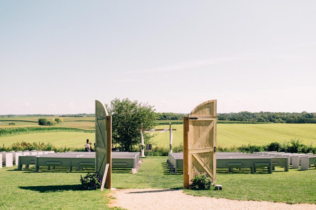 Beautiful ceremony location at Legacy Hill Farm with barn doors open, overlooking the gorgeous farm fields, creating a peaceful, relaxed, and romantic atmosphere.