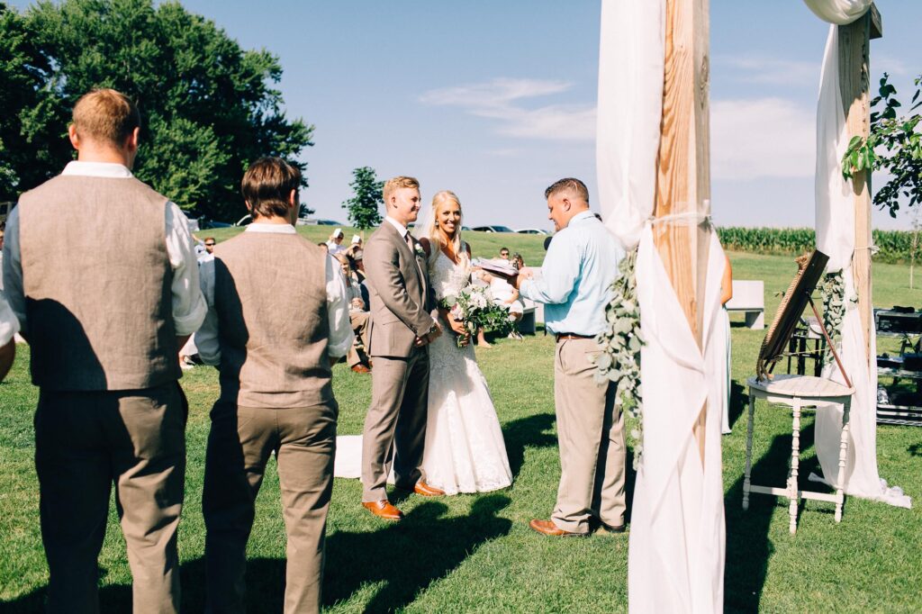 bride and groom stand at the ceremony.