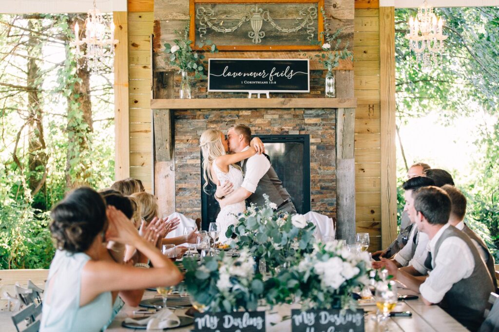 bride and groom kisses at their wedding reception.