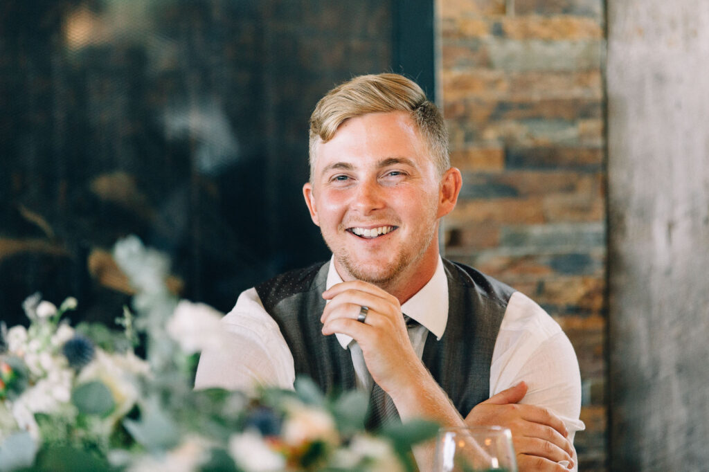 Groom listening to the speech smiling.
