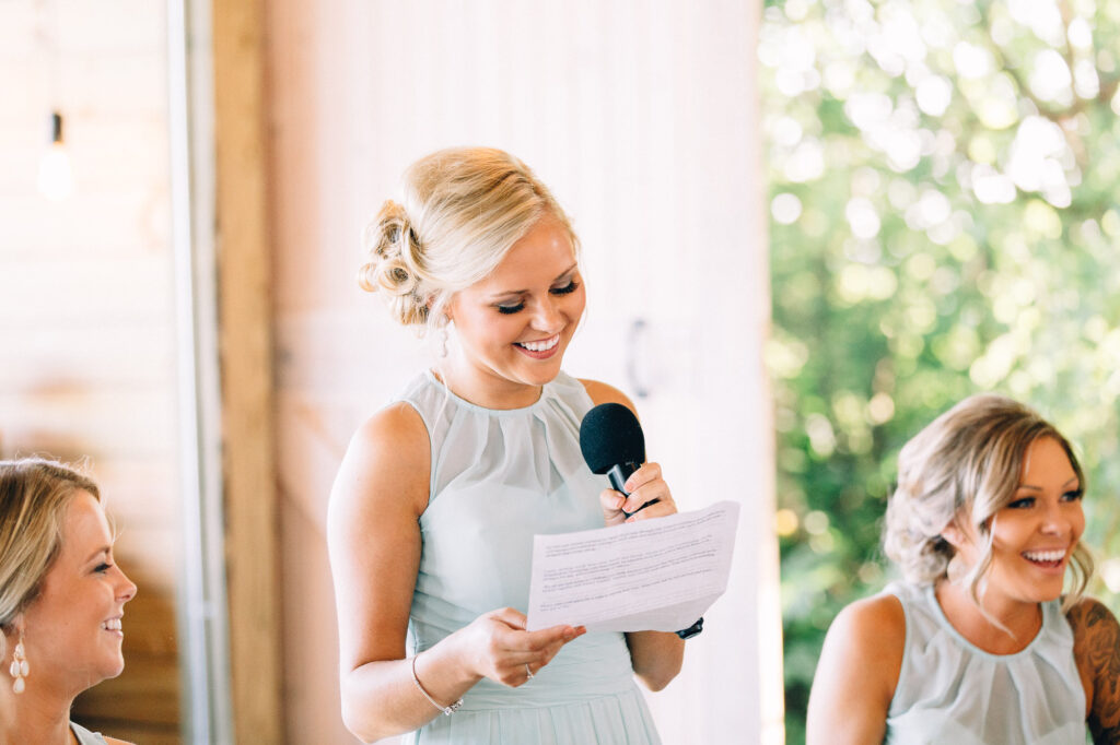 Bridesmaid giving a heartfelt speech during the wedding reception at Legacy Hill Farm.