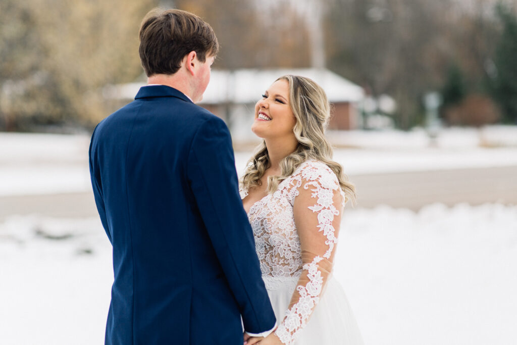 Bride sees him with a big smile during their first look at The Cottage Farmhouse.