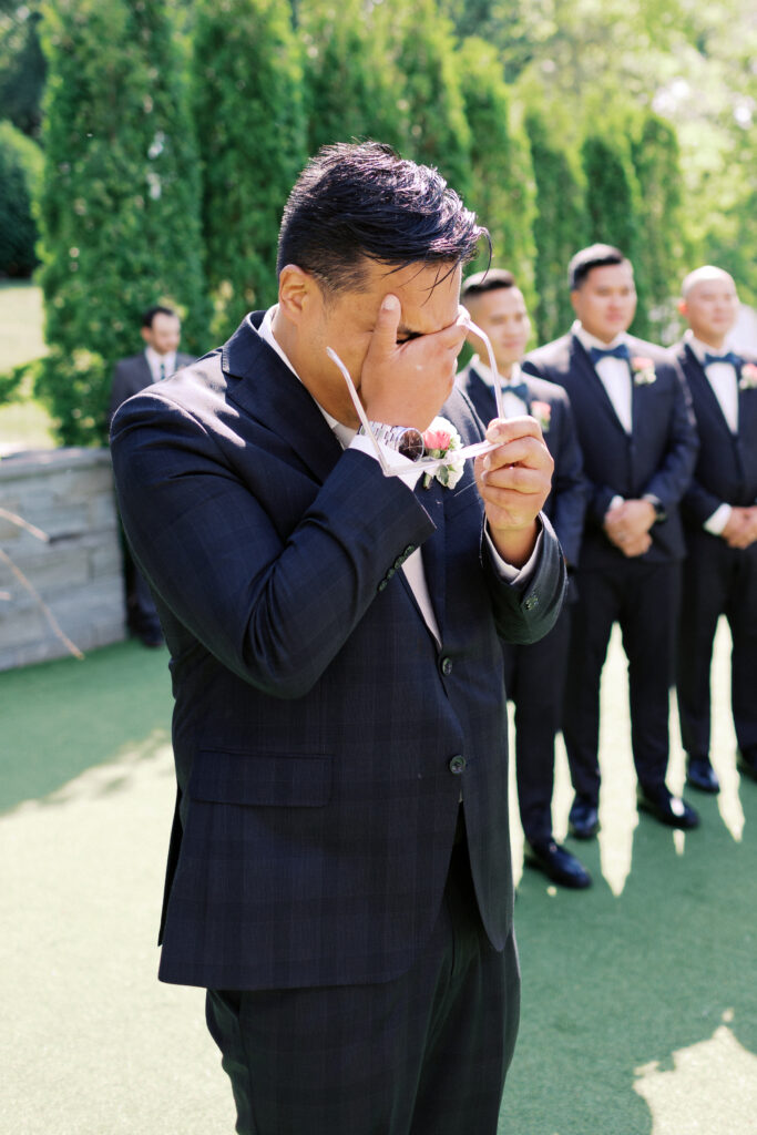 Groom sees his bride walking down the aisle and sheds tears with joy at The Hutton House in Minneapolis, captured by Minnesota wedding photographer Toly Dzyuba Photography. 