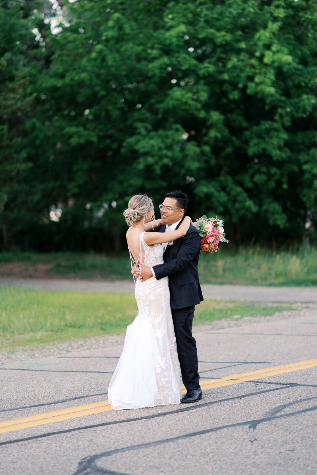 Newlyweds dancing on the street of Minneapolis on their wedding day, captured by minnesota wedding photographer Toly Dzyuba Photography. 