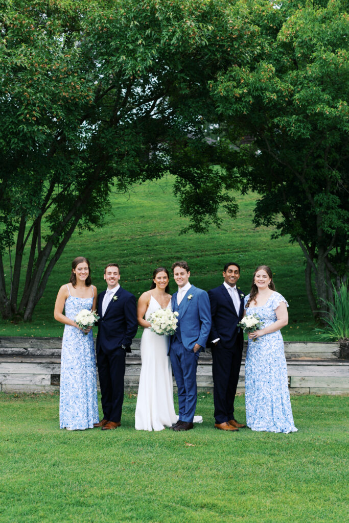 Wedding party group photo with everyone smiling at the camera during a Gull Lake wedding at Madden’s Resort, captured by Minnesota wedding photographer.