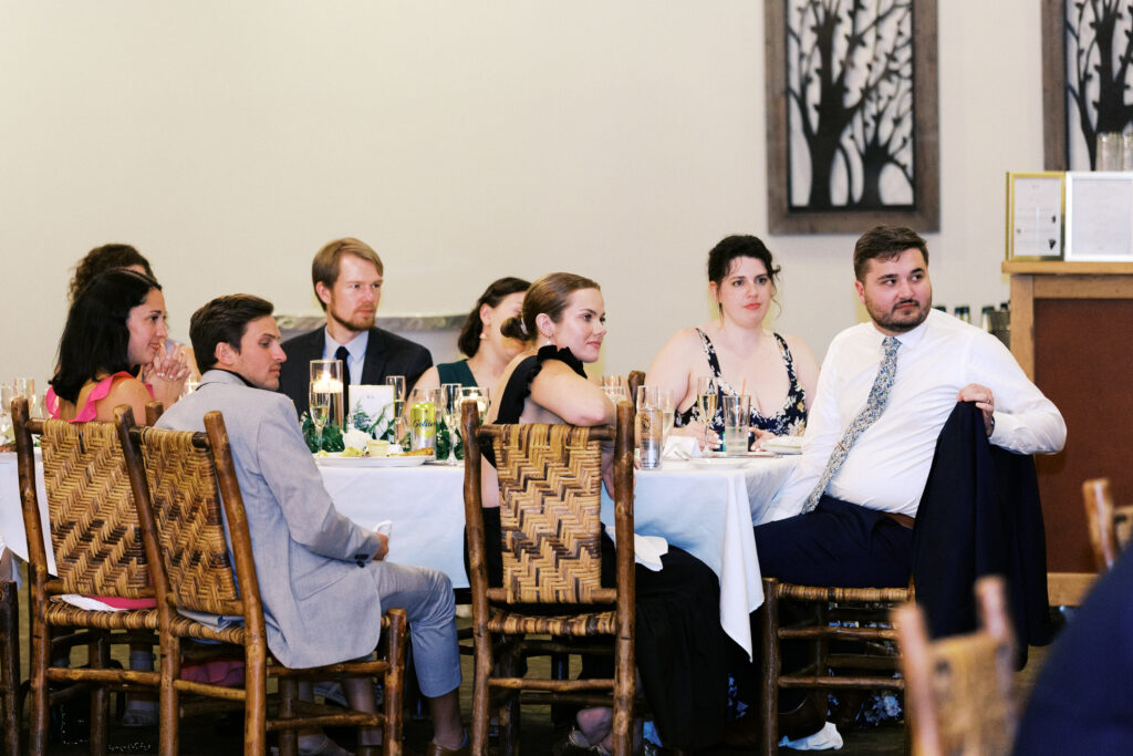 Wedding guests focused and emotional while listening to a heartfelt speech at Madden’s Resort wedding reception, captured by Minnesota wedding photographer.