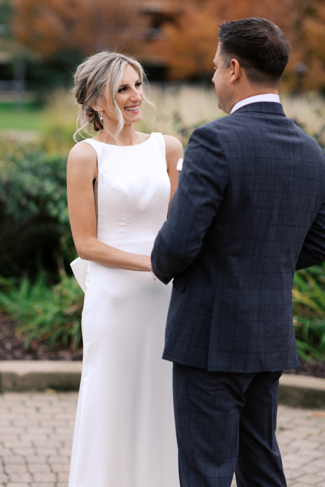 Expression of bride’s face filled with joy as she sees her groom for the first time, captured by the Top Minnesota wedding photographer Toly Dzyuba.