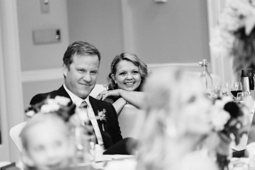 Guests laughing during heartfelt speeches.