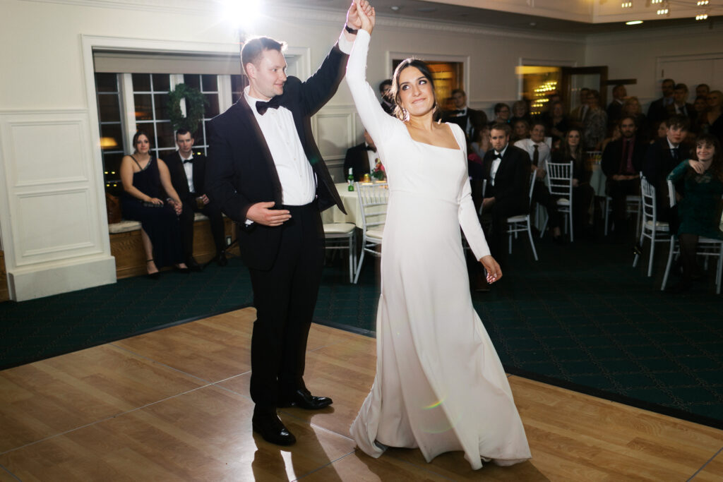 First dance, the groom spins the bride at the St. Paul College Club wedding venue.