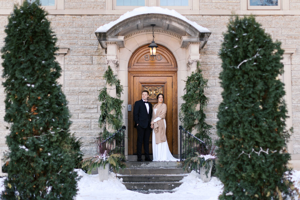 Snowy wedding portraits outside St. Paul College Club captured by Minnesota wedding photographer.