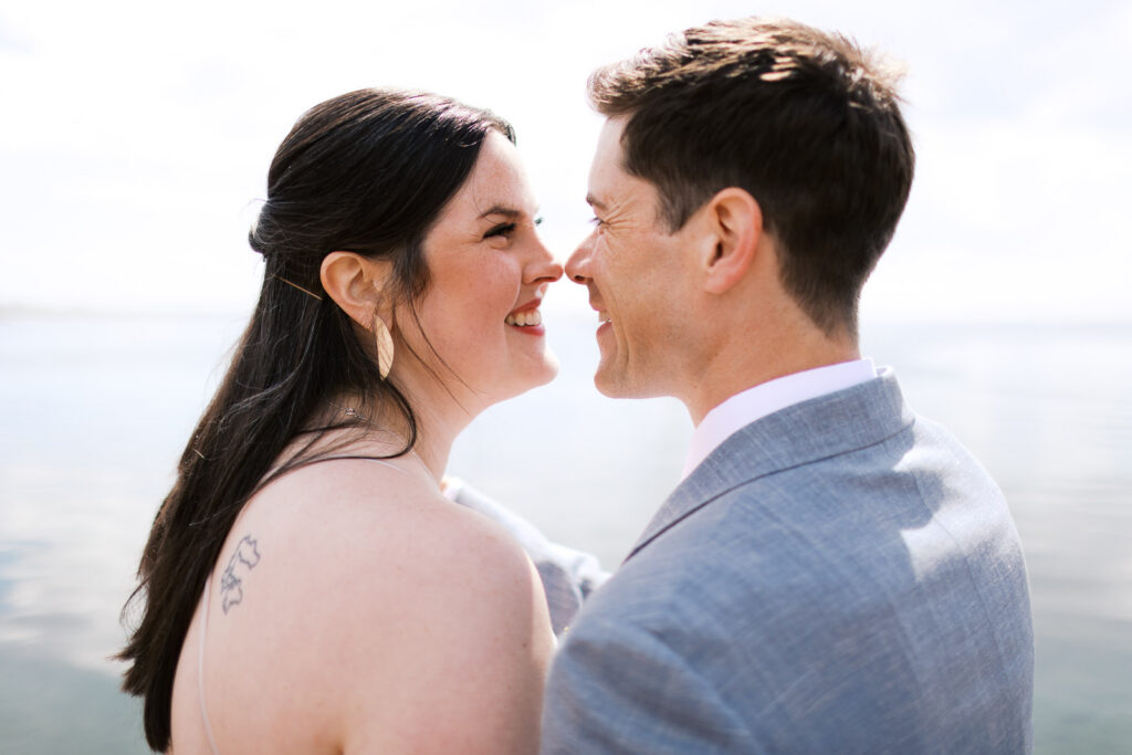 Newlyweds share a moment by the Lake Superior at The Mayhem Inn, captured by Grand Marais wedding photographer.