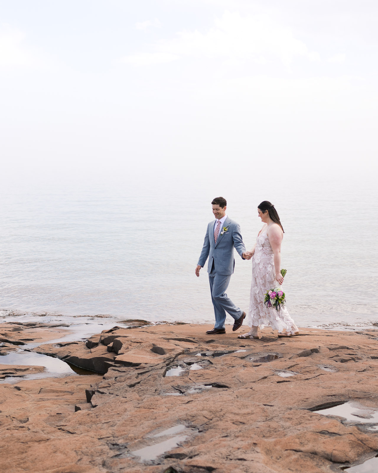Wedding couple overlooking Lake Superior on Minnesota's North Shore near Grand Marais.